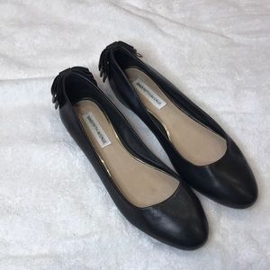 Black leather flats.